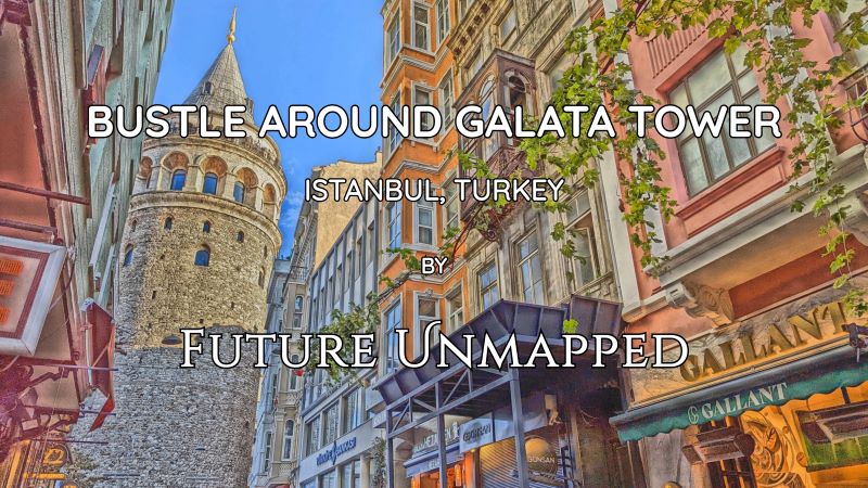 Onlookers on top level of symbolic medieval watchtower museum - overlooking vibrant crowds and narrow streets - absorb impressive city views from observation deck.