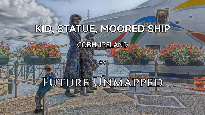 Young human takes break outside museum of seaport town - next to docked cruise ship - with bronze statues of first people admitted to US through Ellis Island immigration centre.