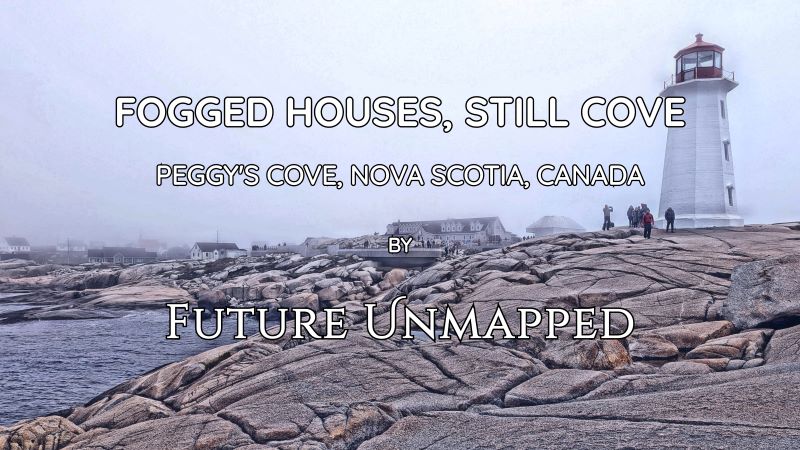 Dense fog around iconic lighthouse and weathered granite rocks - in small, rural, tourist location - etherealizes maritime village and barely-visible local church.